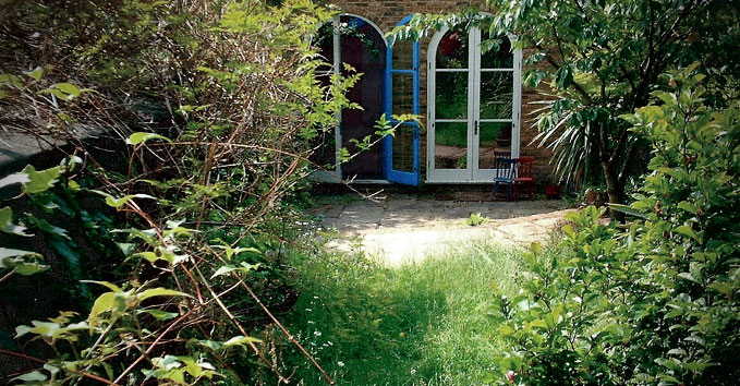 An overgrown garden shading the house