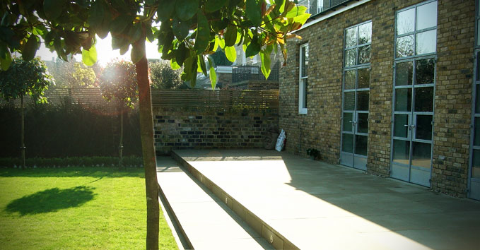 The house, patio and lawn with new trees